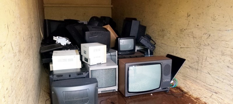 Kaputte Fernseher in einem Container